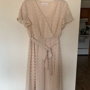 Cream colored faux-wrap dress with 3D detail